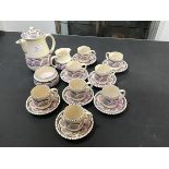 A Honiton coffee set consisting of coffee pot, jug, cream and eight cups and saucers