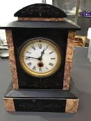 A Victorian slate mantle clock, the marble body with granite slips, with enamelled dial and roman