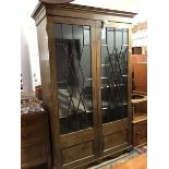 A 19th century mahogany bookcase cabinet, the moulded cornice above a pair of glazed astragal