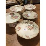 A 19thc Limoges fruit set with rose pattern on ivory ground, comprising four comports and six