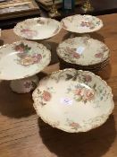 A 19thc Limoges fruit set with rose pattern on ivory ground, comprising four comports and six