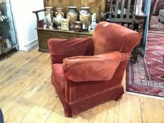 An Edwardian mahogany armchair, the upholstered back, arms and seat on square tapering legs and