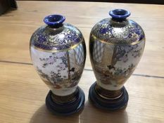 A pair of miniature Japanese Satsuma baluster vases with blue and gilt panels depicting mother and