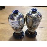 A pair of miniature Japanese Satsuma baluster vases with blue and gilt panels depicting mother and