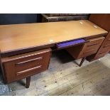 A G-Plan teak dressing table, with velvet-lined frieze drawer and four further drawers, raised on