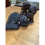 A mixed lot of African carved hardwood figures including a wall mask and a crosslegged man