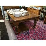 A late Victorian oak telescopic dining table, the rectangular top enclosing three additional leaves,