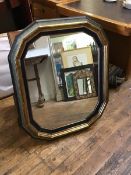 A modern gilt and painted octagonal wall mirror, the moulded cushion frame enclosing a rectangular