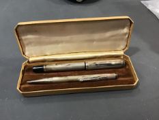 A silver fountain pen together with a silver pencil, with engine turned decoration, manufacture mark