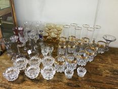A mixed lot of mainly vintage stemmed glasses and beakers etc. together with vases, candlesticks,