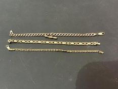 A 9ct gold fancy link lady's bracelet together with a yellow metal guard link bracelet and another