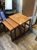 A set of three 1960s graduated teak tables, each with impressed stamp 73 on the underside (largest