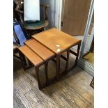 A set of three 1960s graduated teak tables, each with impressed stamp 73 on the underside (largest