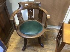 An Art Nouveau style elm desk chair c.1910, the hoop-shaped top-rail and pierced splat above a