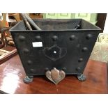 A rectangular tapered steel coal bin with twin handles and cast claw feet together with tools, h28cm