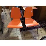 A pair of Vilmar orange plywood chairs for IKEA, the laminated one-piece back and seat on steel