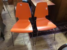 A pair of Vilmar orange plywood chairs for IKEA, the laminated one-piece back and seat on steel