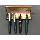 A group of four Parker fountain pens, two with gold nibs