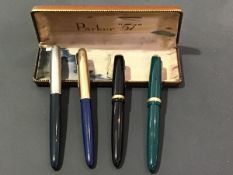 A group of four Parker fountain pens, two with gold nibs