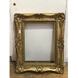 A Victorian ornately moulded gilt frame (internal: 45cm x 61cm)