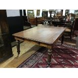 A Victorian mahogany library table, the rectangular top with rounded corners above a plain apron