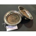 A pair of Sheffield plate wine coasters or bottle slides with turned wooden bases d.12cm