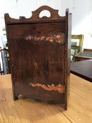 An Edwardian Arts and Crafts oak pipesmokers' cabinet, the rectangular top with ledgeback, fitted