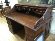 A walnut roll-top desk by Cutler & Sons, Buffalo New York, the serpentine tambour top enclosing