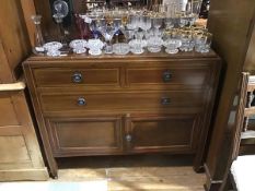 An Edwardian mahogany and chequer-banded chest, fitted with three drawers and a pair of cupboards,