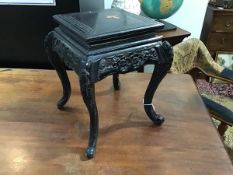 A 20thc Japanese ebonised jardiniere stand, the rectangular top with incised decoration above a