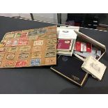 A collection of match boxes mounted on a wooden board together with a collection of used cigarette
