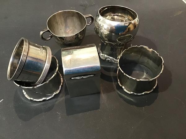 A mixed lot of hallmarked silver including napkin rings, a twin handled Christening mug and a