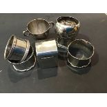 A mixed lot of hallmarked silver including napkin rings, a twin handled Christening mug and a