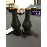 A pair of Chinese small baluster lacquered wood vases with celadon green decoration on stands (