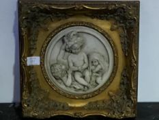 A 19thc style marble circular composition panel, Three Infants, in moulded gilt frame (excl.