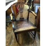 A George III oak country elbow chair c.1800, the shield-shaped back and pierced splat above a