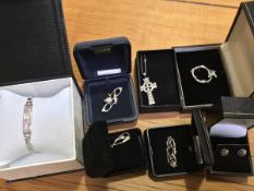 A mixed lot of silver jewellery including a Celtic cross, brooches, Mackintosh style earrings and