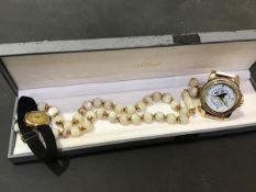 A mixed lot comprising a string of mother of pearl beads, a 9ct gold lady's wristwatch on black