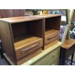 A pair of teak G-Plan bedside cabinets, each with open recess and drawer below. bears manufacturer's