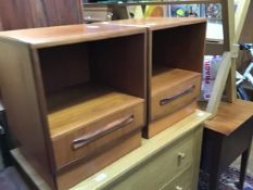 A pair of teak G-Plan bedside cabinets, each with open recess and drawer below. bears manufacturer's