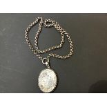 A Victorian oval engraved white metal locket on belcher style white metal chain (l.47cm) (32.3g)