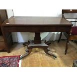 A Regency mahogany pedestal table, the rectangular top above a tapering column on hipped legs