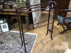 An Edwardian mahogany and boxwood lined towel rail, the arched frame with five turned rails (86 x