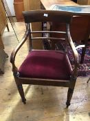 A George IV mahogany elbow chair c1830, the curved top trail above a pair of down-swept arms with