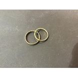 An 18ct gold wedding band (3g), together with a unmarked yellow metal wedding band (1.8g) (2)