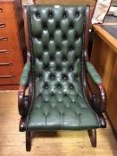 A modern mahogany and buttoned-leather library chair, with downswept arms and X-frame base (97cm