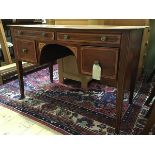 A 19th century mahogany and satinwood-banded dressing table, the rectangular top above four