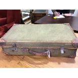 A vintage canvas covered suitcase containing various prints etc.