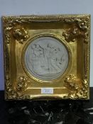 A gilt frame enclosing a moulded circular panel of Athenian Lovers (external: 27cm x 27cm)