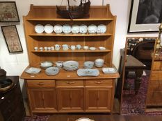 A Ercol modern elm Cotswold style dresser, the raised plate rack above three drawers and three